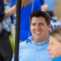 Guests sitting at a table talking.